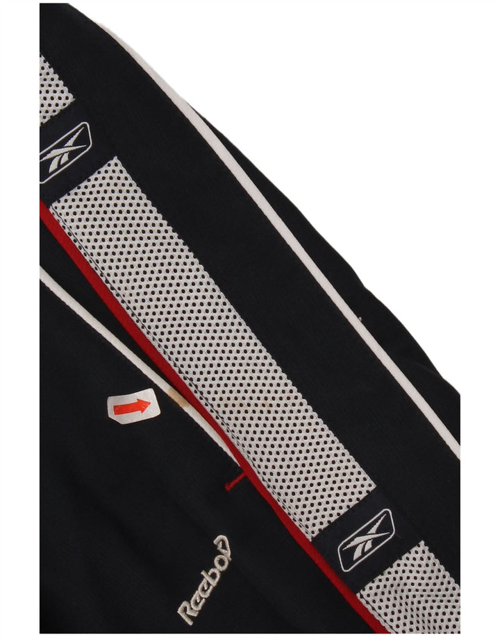 Calças de treino gráfico Reebok Boys 14-15 anos XL azul marinho Colourblock