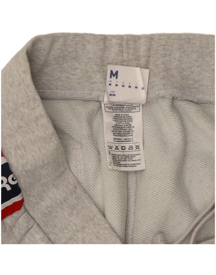 Calça de treino masculina Reebok Graphic Joggers cinza médio colorblock