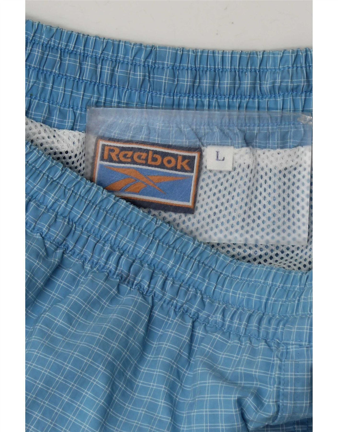 Shorts esportivos masculinos Reebok grande xadrez azul