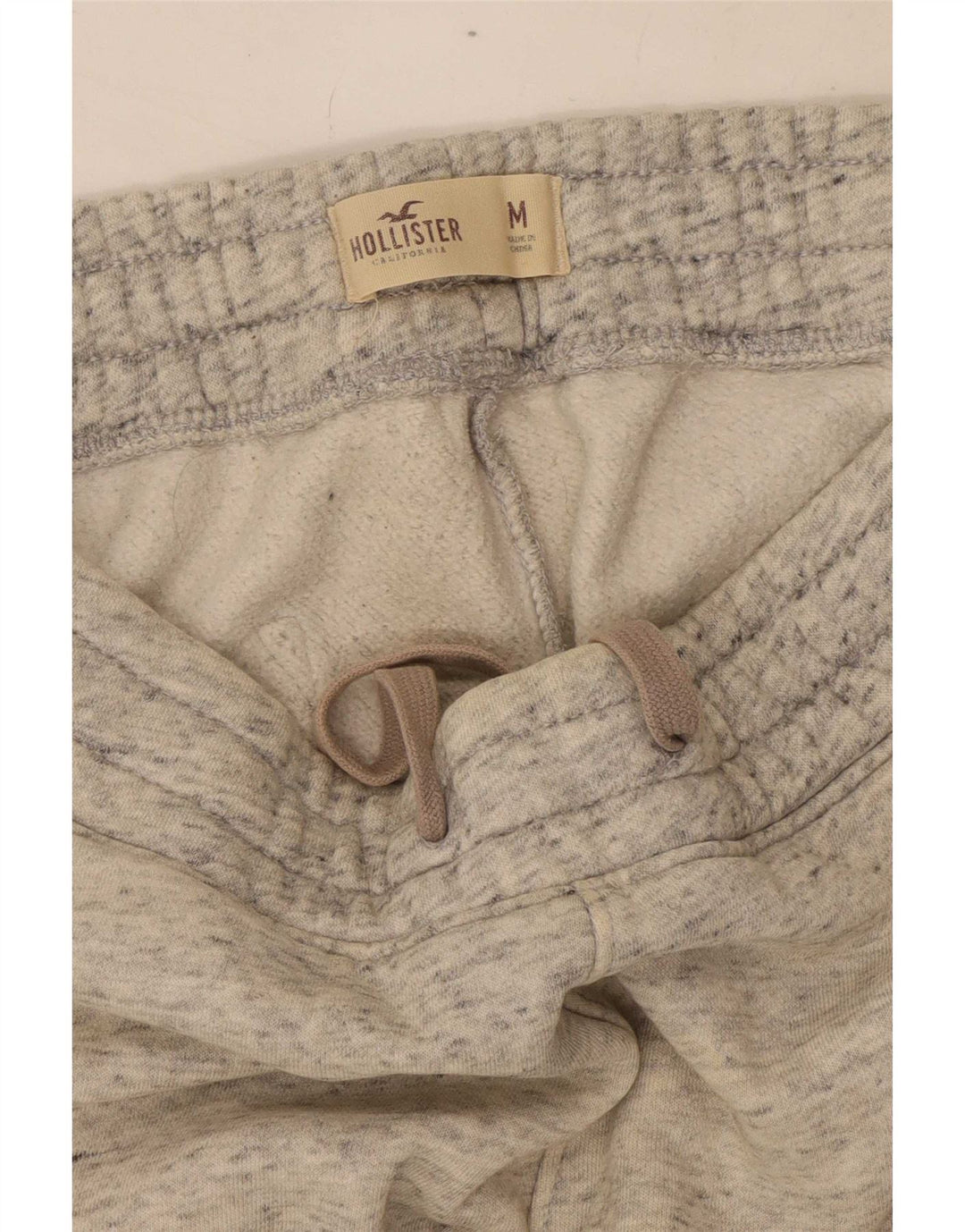 Calça de treino masculina Hollister com estampa gráfica cinza médio algodão manchado