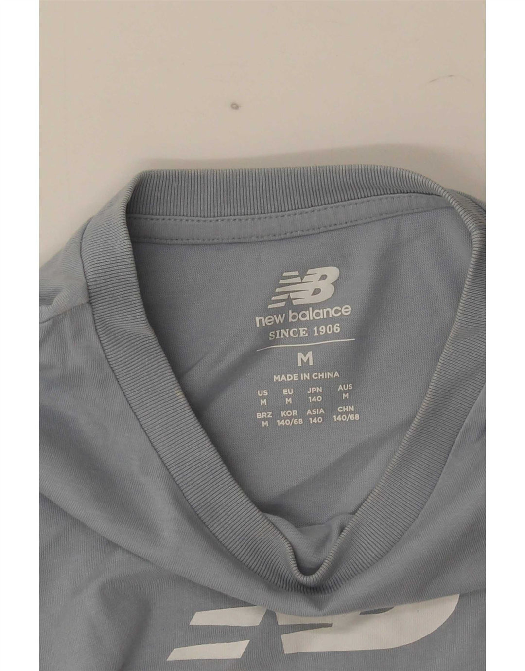 Camiseta gráfica New Balance Boys 9-10 anos azul médio