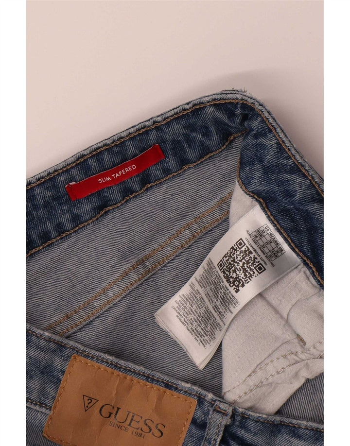 Calça jeans feminina Guess Slim Tapered W32 L34 azul poliéster