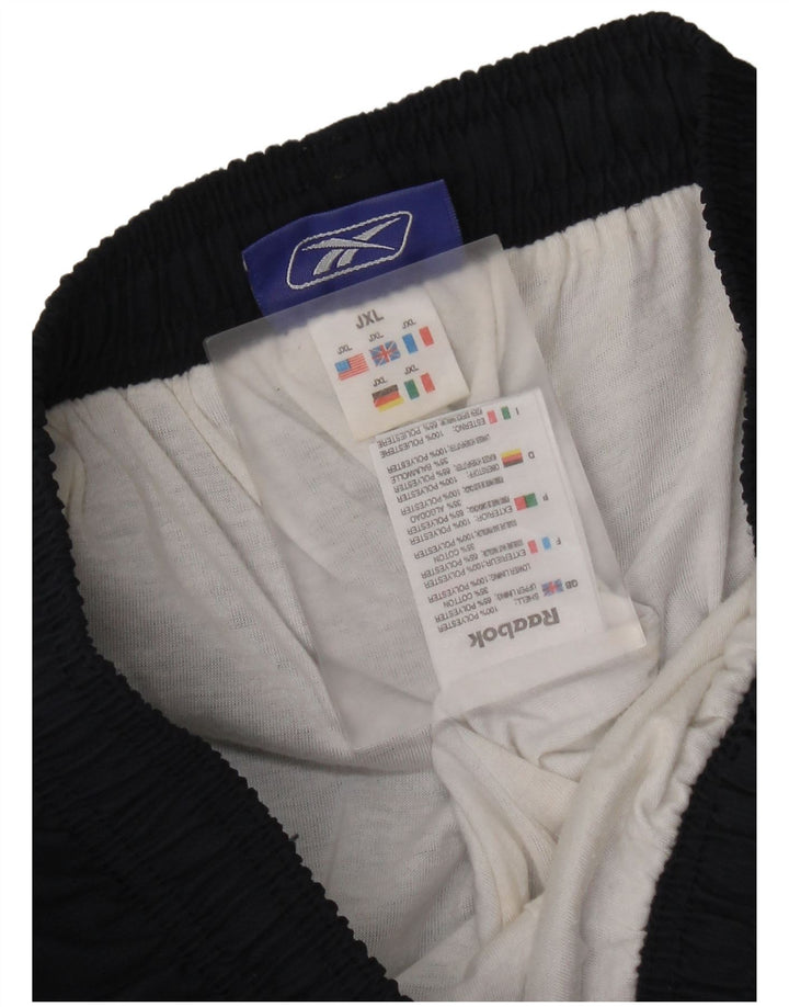 Calças de treino gráfico Reebok Boys 14-15 anos XL azul marinho Colourblock